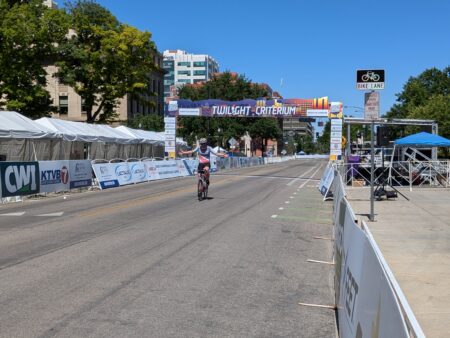 Student Doctor Butler crosses the finish line at the Boise Twilight Criterium.